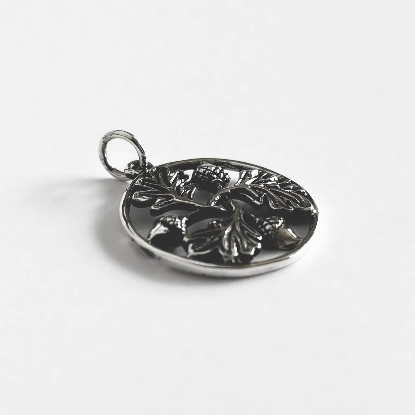 Three acorns and three oak leaves in a ring charm
