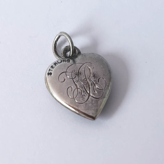 Sterling silver puffy heart charm with a fleur de lis symbol and engraved KR