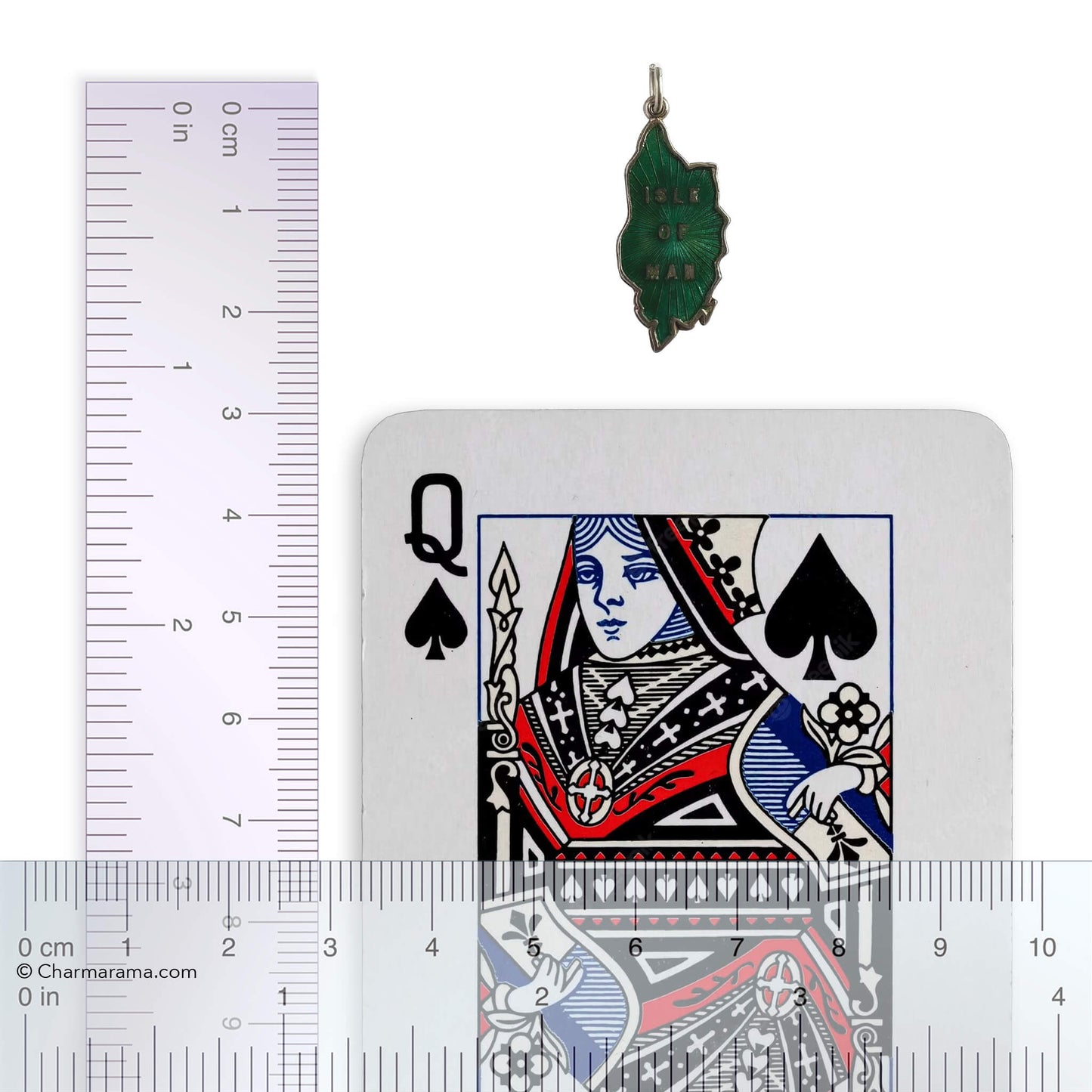 Green pendant next to a playing card with a ruler for scale