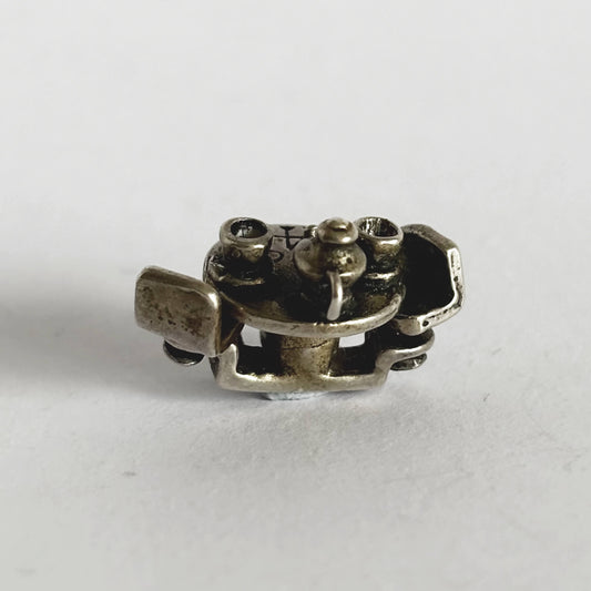 silver cafe table with teacups and teapot charm on a white background