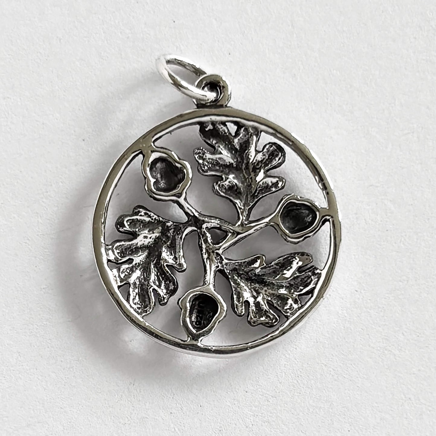 A silver acorns and oak leaves in a ring charm