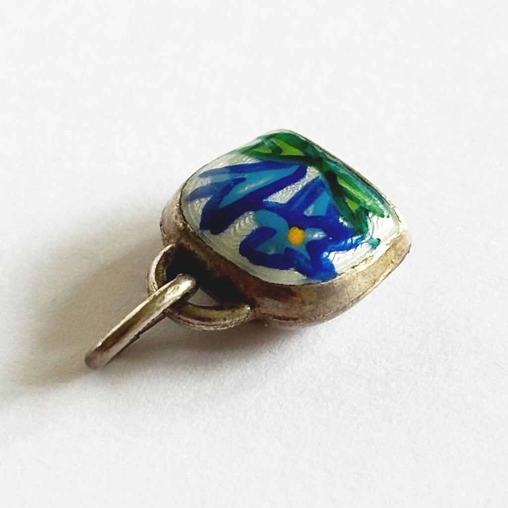 Vintage Silver Swiss Bell Charm with blue gentian flower on a white background