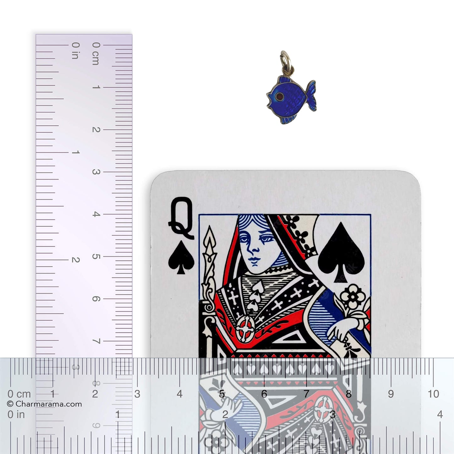 Blue fish pendant next to a playing card with a ruler for scale