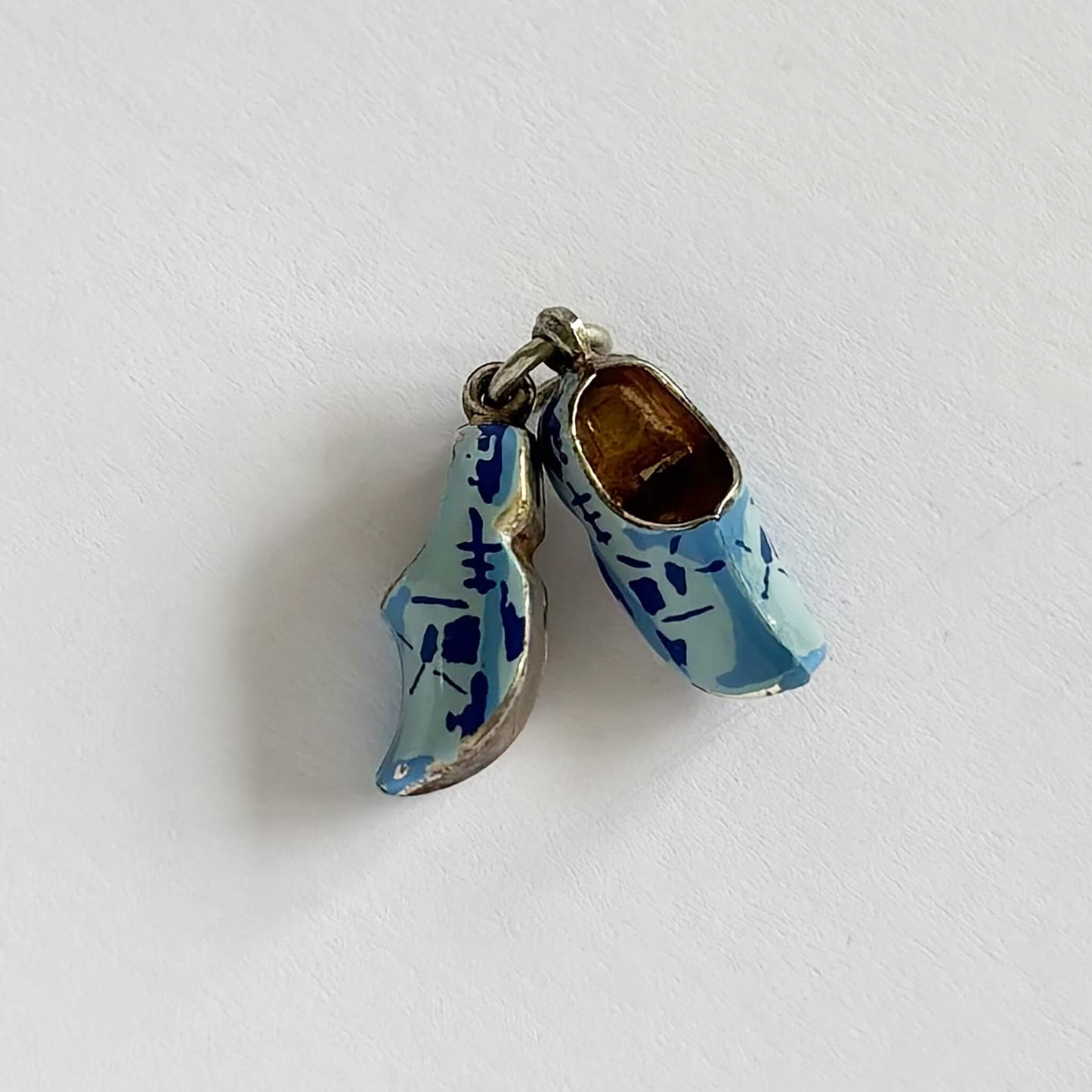 A pair of blue Dutch clogs pendant on a white background