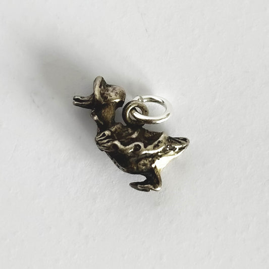 Small silver mother goose charm on a white background