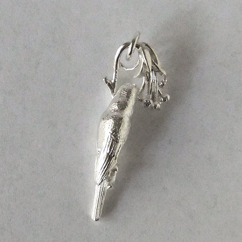 Silver lorikeet and flowers charm on grey background