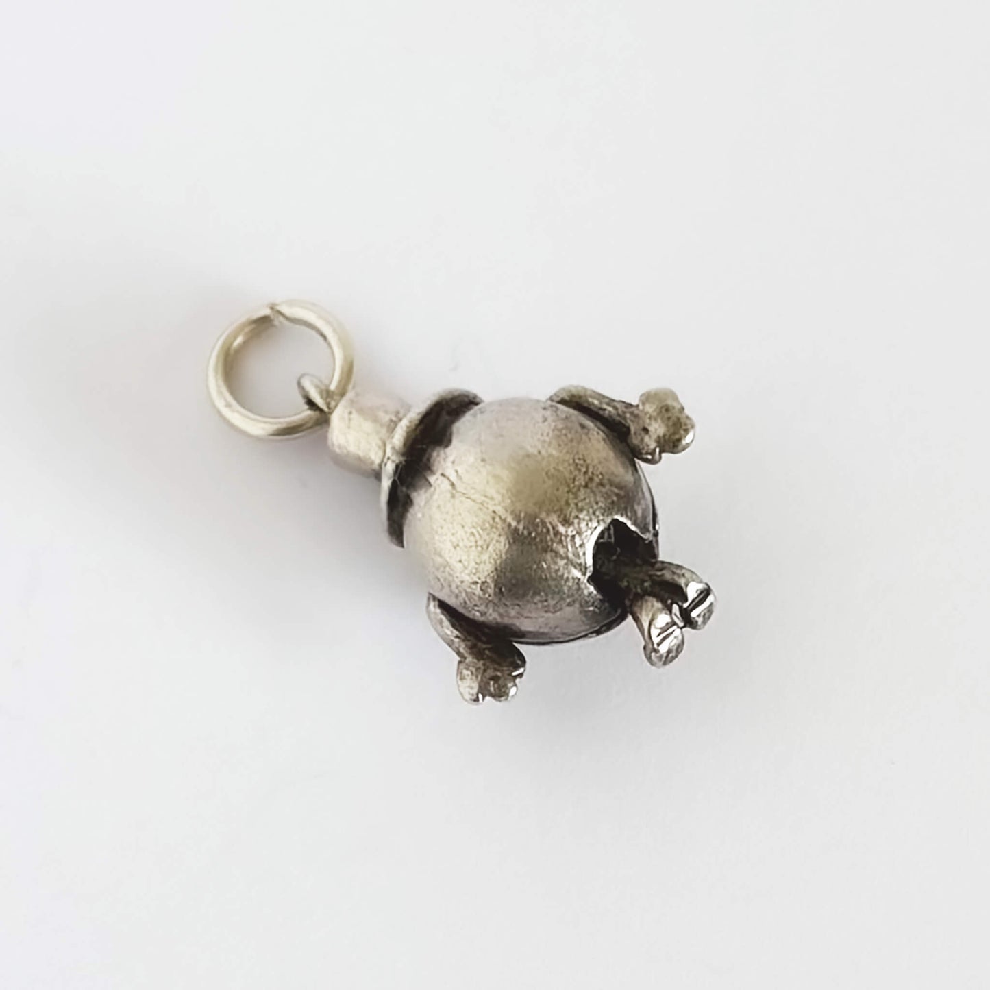 Silver Mr Happy pendant on a white background