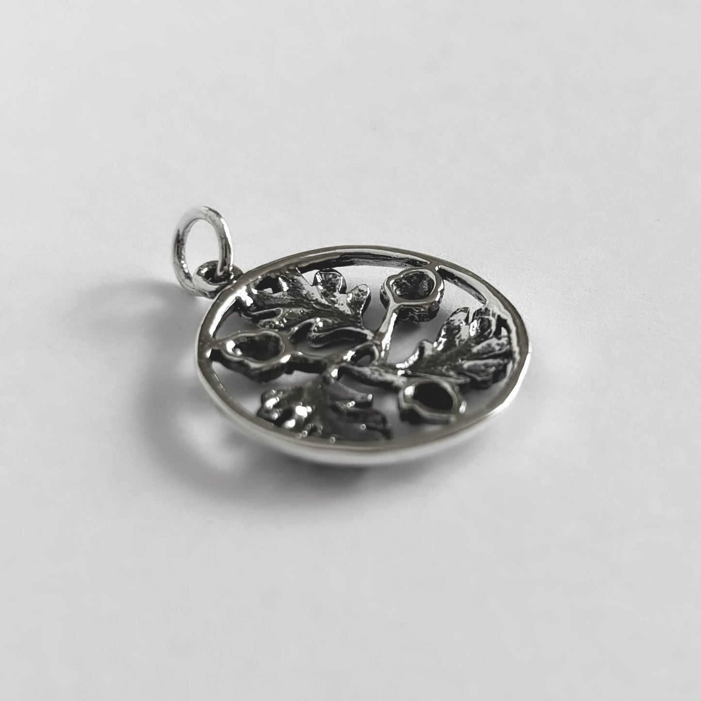 Sterling silver circle of three acorns and leaves charm