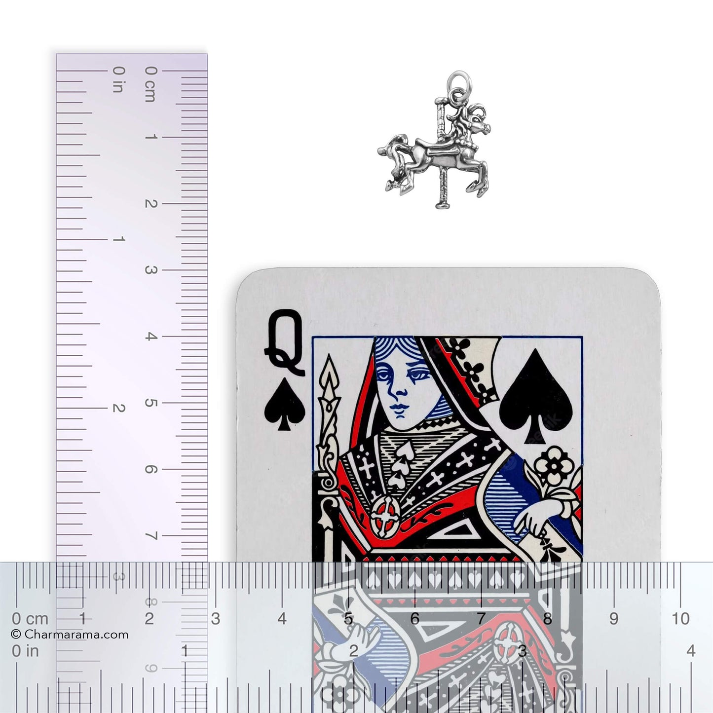Silver carousel horse charm with playing card and ruler for scale