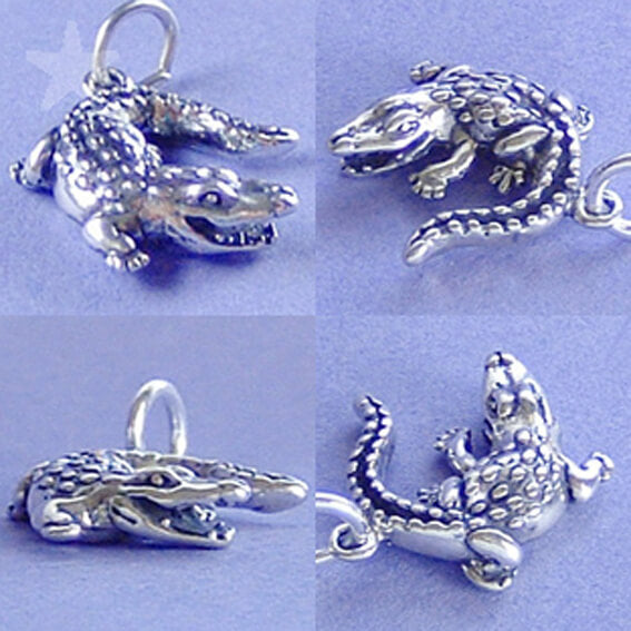 Four silver alligator pendants on a light purple background