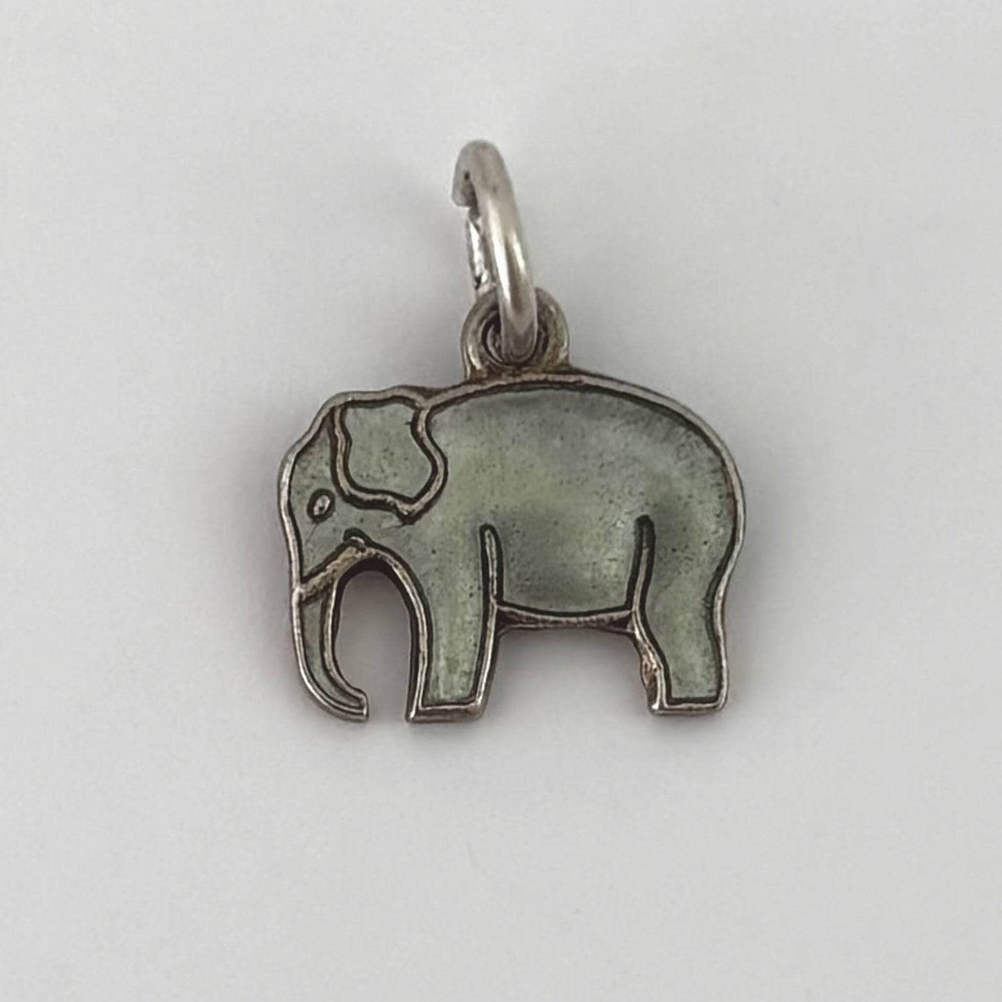 Silver elephant pendant on a white background