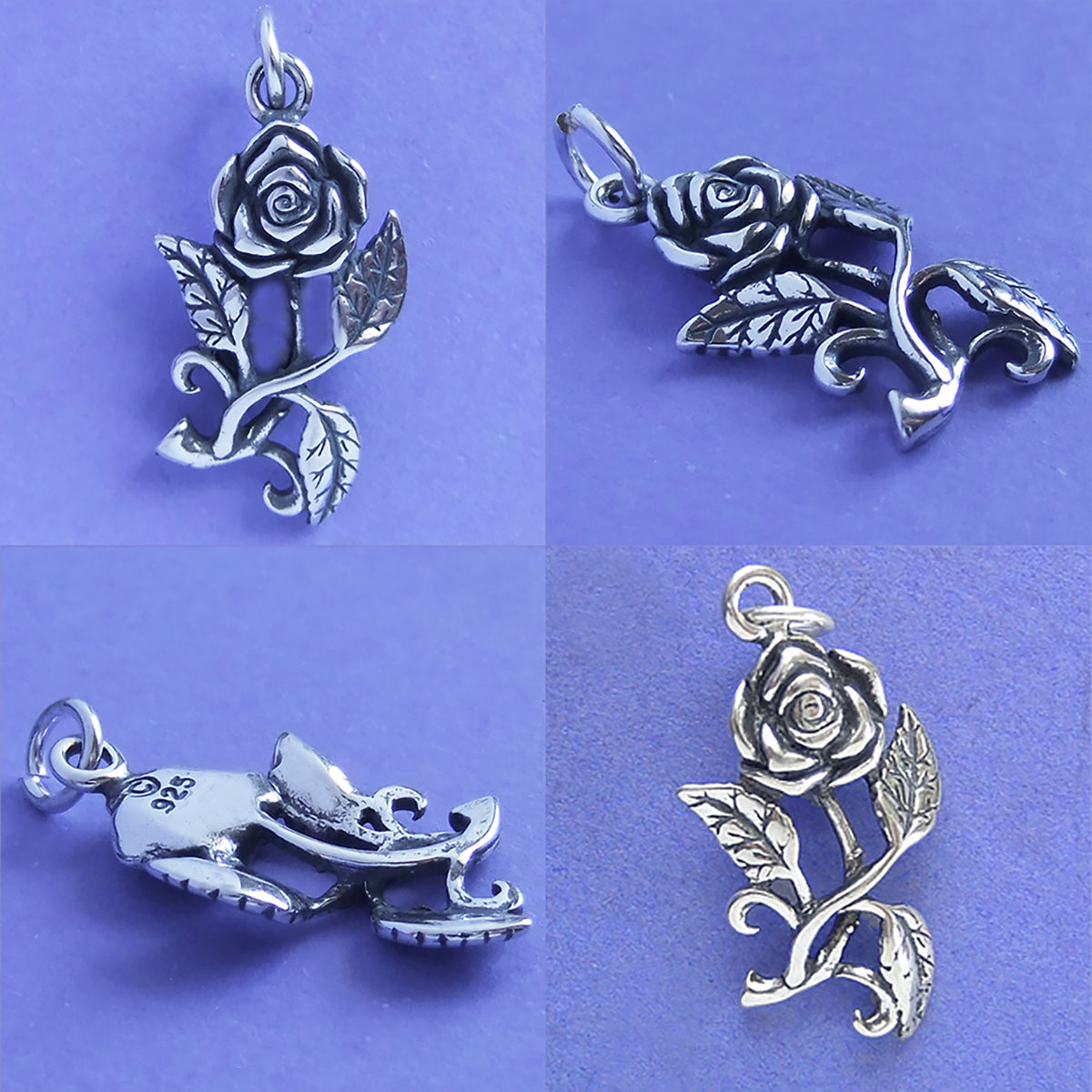 Four silver rose pendants on a purple background
