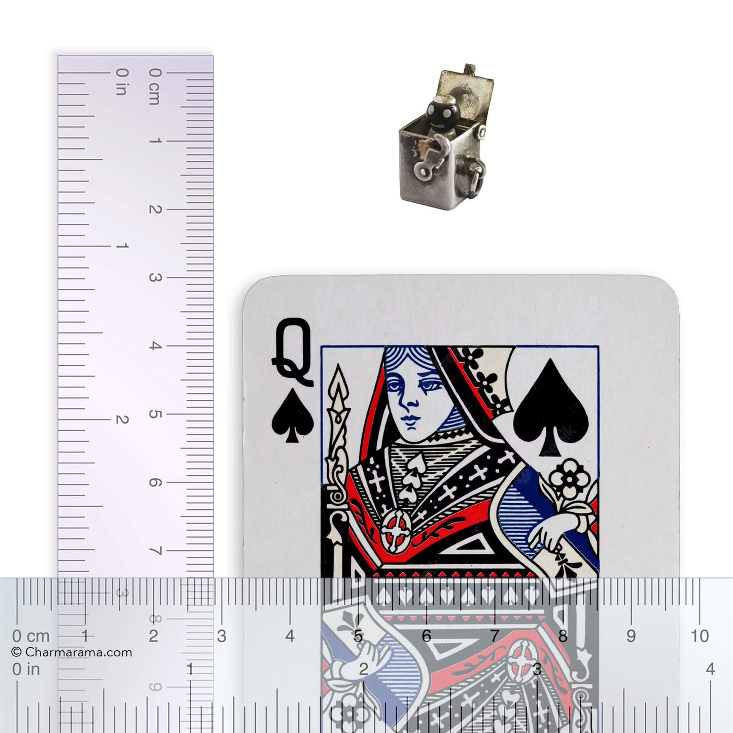 Vintage sterling silver Jack-in-the-box charm with playing card and ruler, on white background