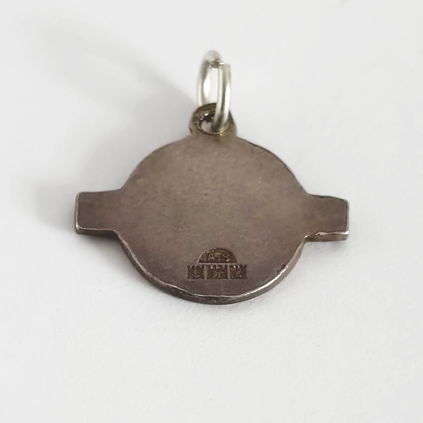Silver London Underground pendant with hallmarks on a white background