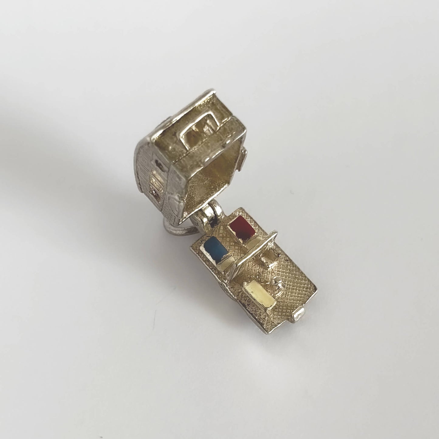 Vintage silver caravan charm opens to enamel furniture