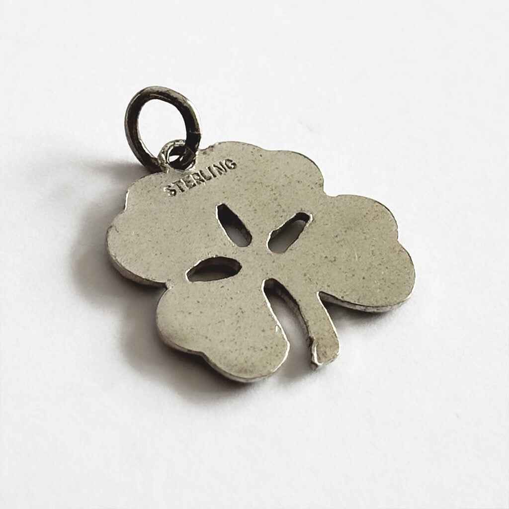 Silver four-leaf clover pendant on a white background