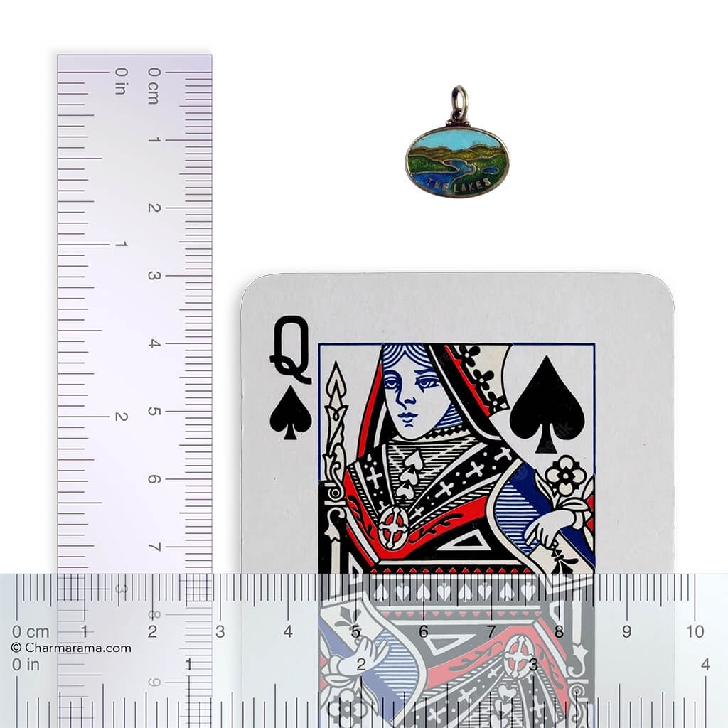 Lake District pendant with ruler and playing card for scale on white background