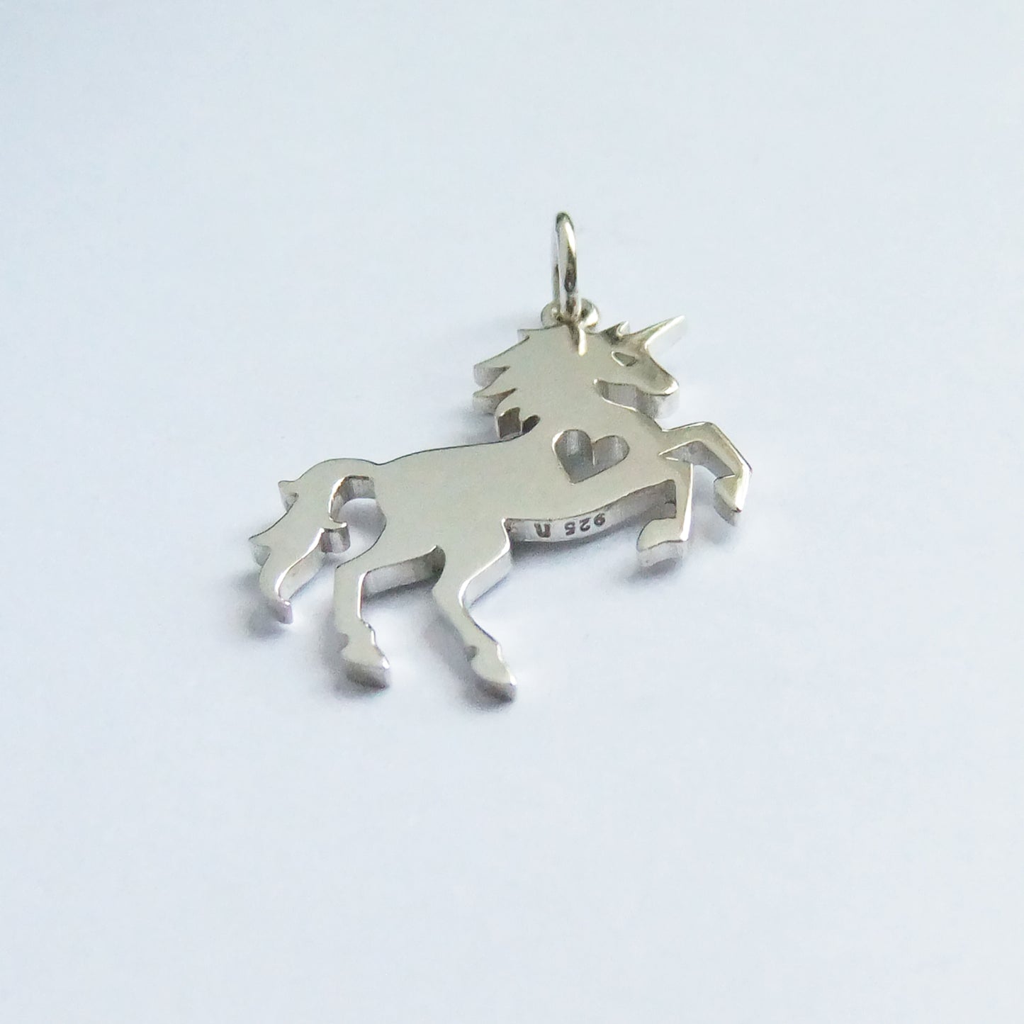 unicorn silhouette with heart charm