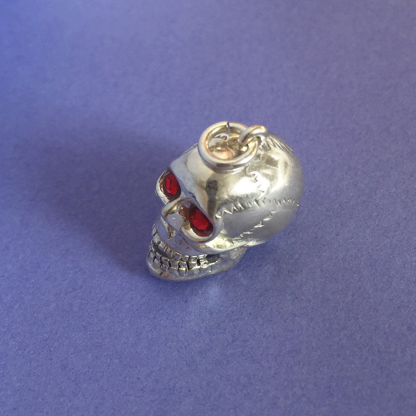 skull charm with red crystal eyes