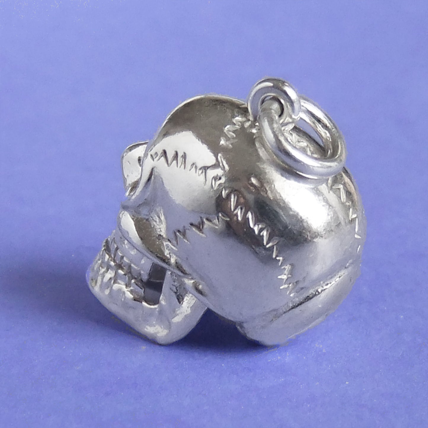 skull charm with red crystal eyes