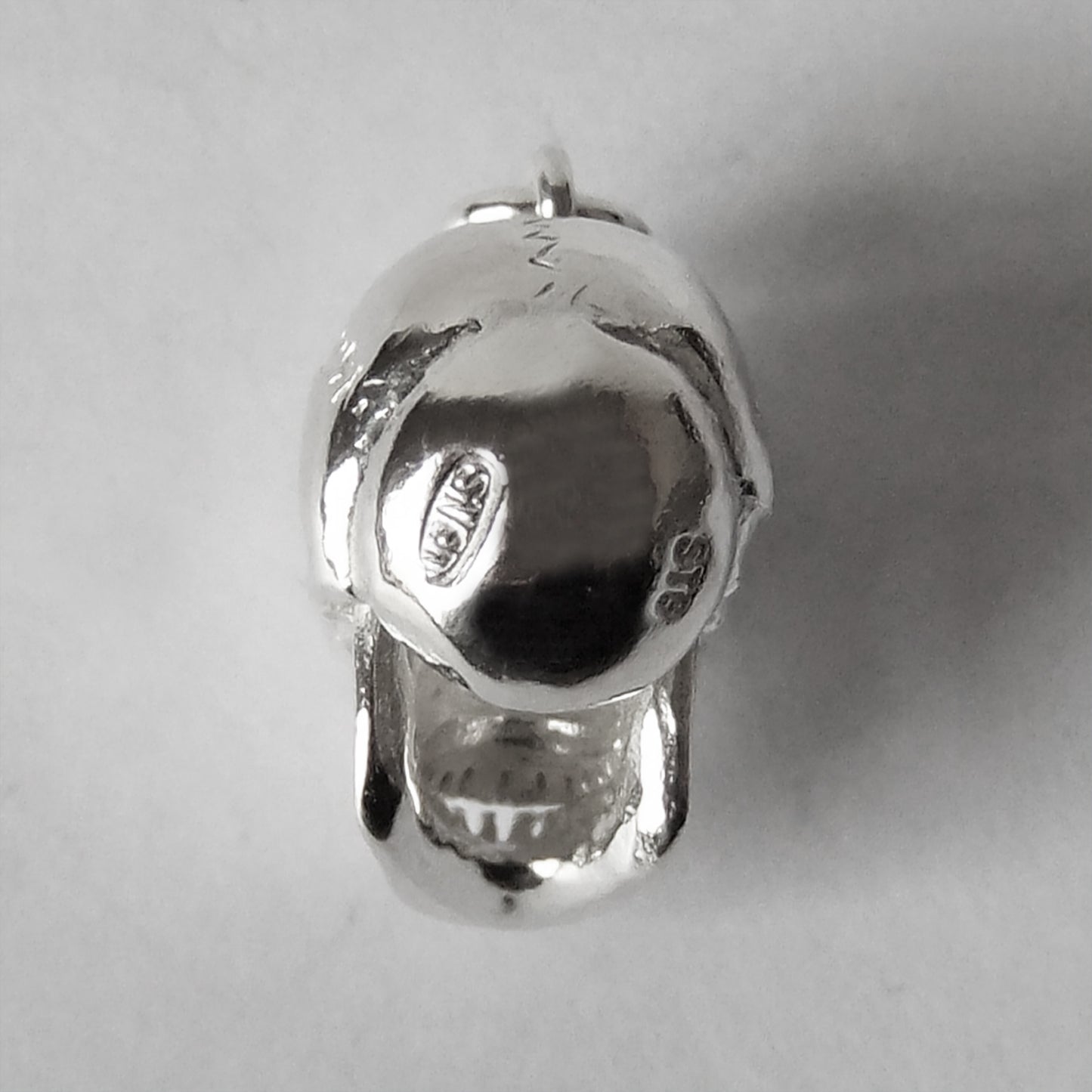 skull charm with red crystal eyes