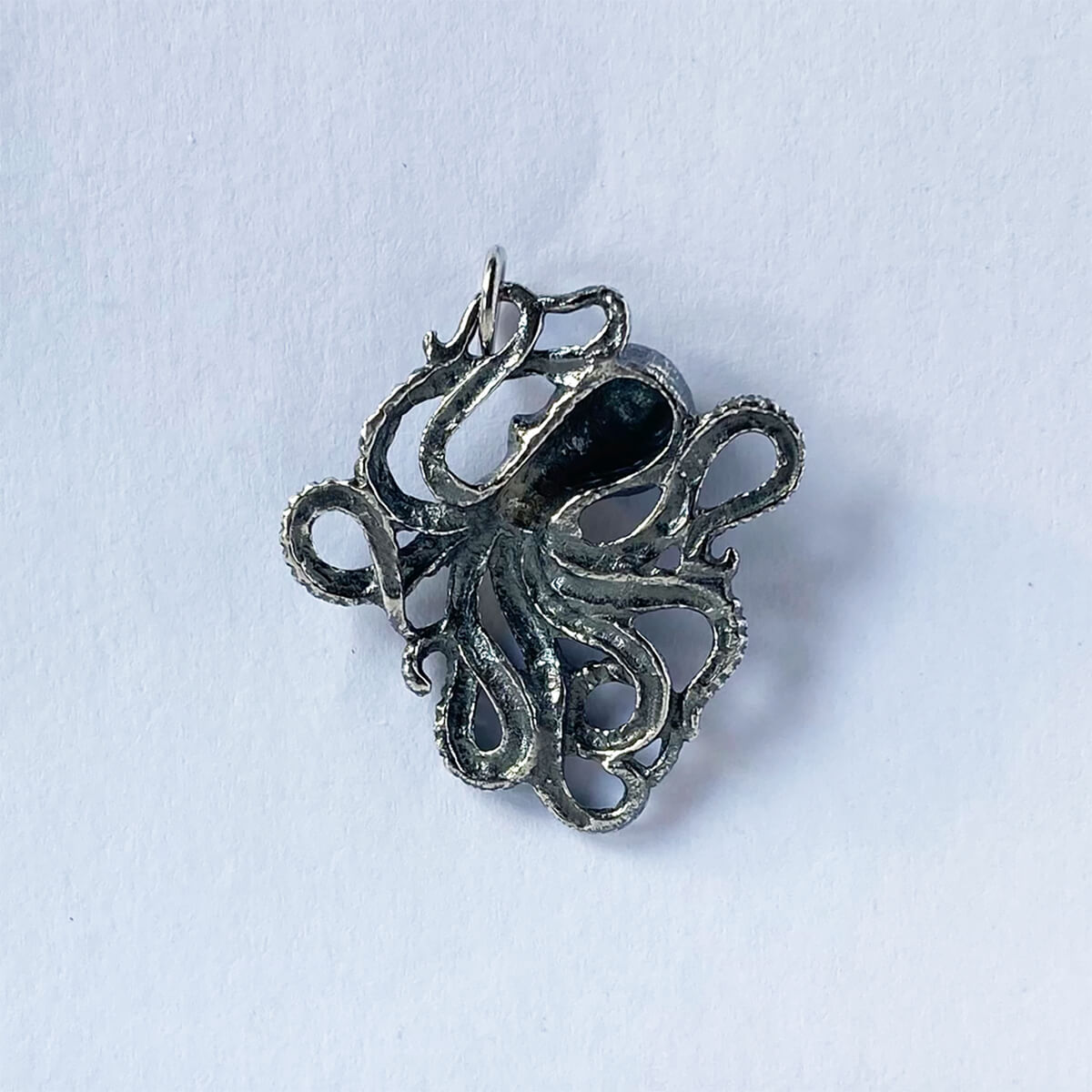 Rear view of a sterling silver octopus pendant