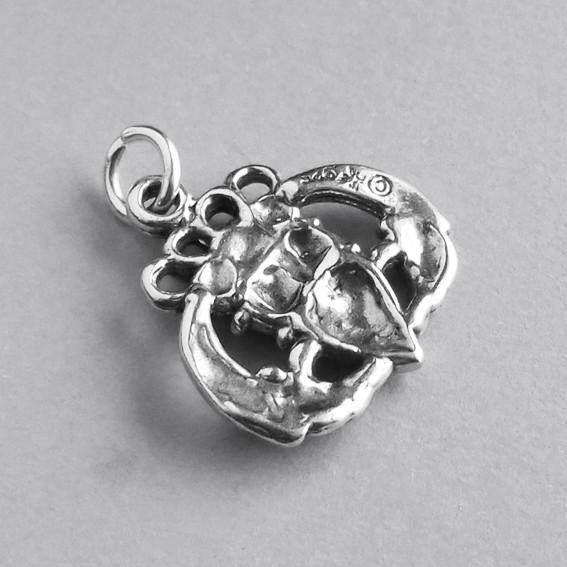 back of Irish Claddagh hands heart crown symbol on grey background