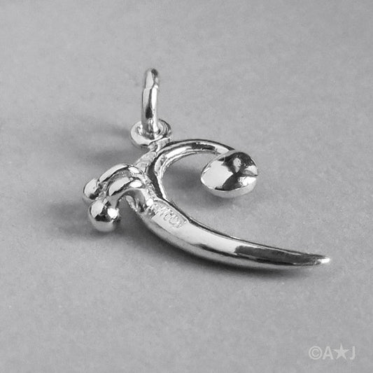 back of a silver bass clef charm on a grey background
