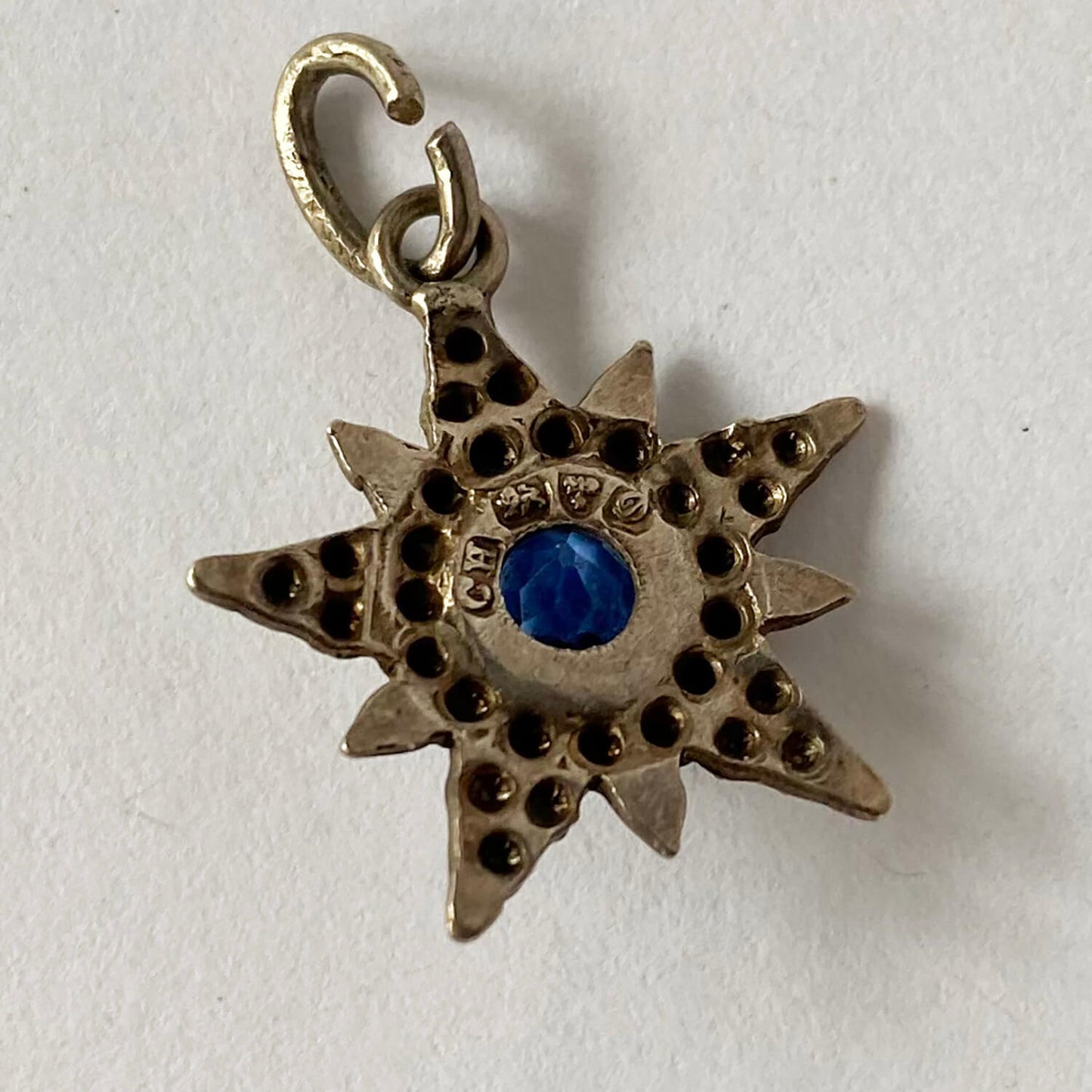 English silver antique star pendant with blue centre stone made in 1904 by Charles Horner