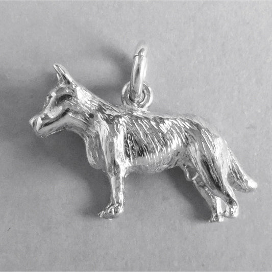 Silver blue heeler dog charm seen from side on a grey background.