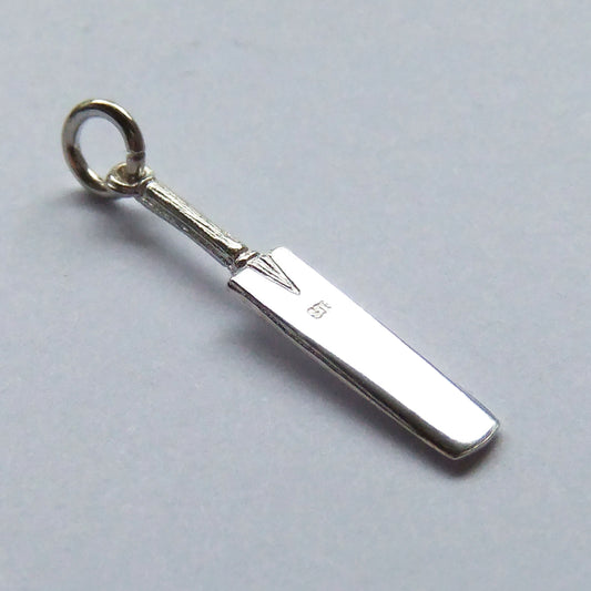 Sterling silver cricket bat charm on a grey background