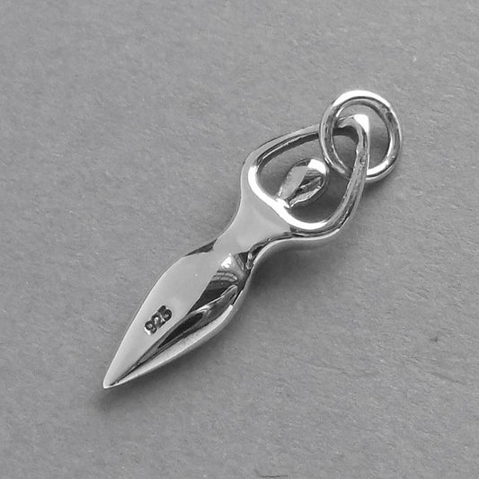 Back of a sterling silver fertility goddess charm on a grey background