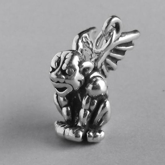 Sterling silver gargoyle charm on a grey background
