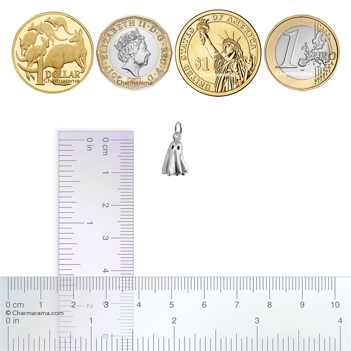 Sterling silver ghost charm with coins and ruler for scale on a white background