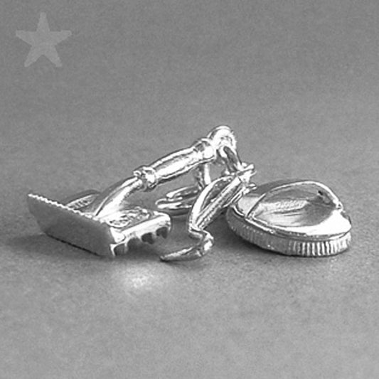Sterling silver grooming kit charm on a grey background