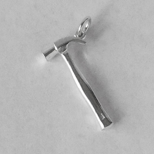 Sterling silver hammer charm on a grey background