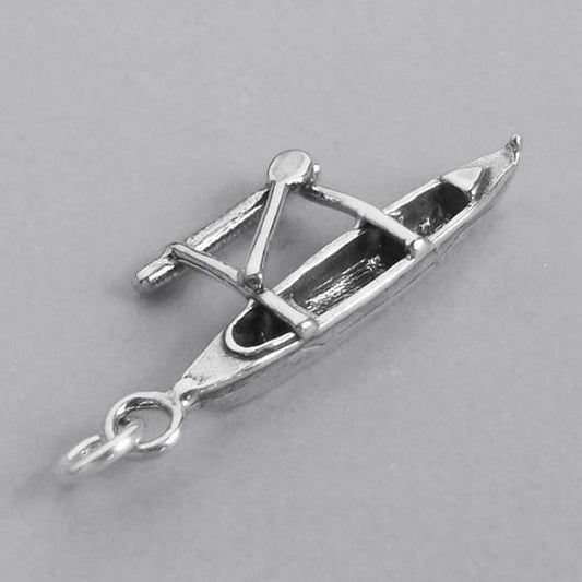 canoe and outrigger charm on grey background