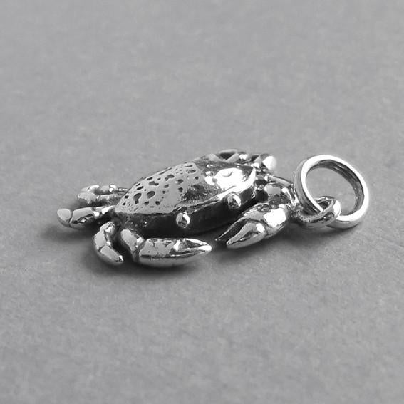 sterling silver crab pendant front view on grey background