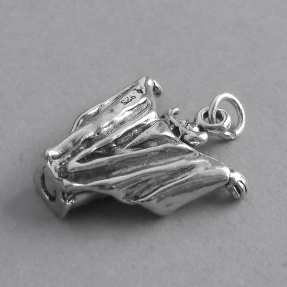silver dracula charm viewed from back on grey background