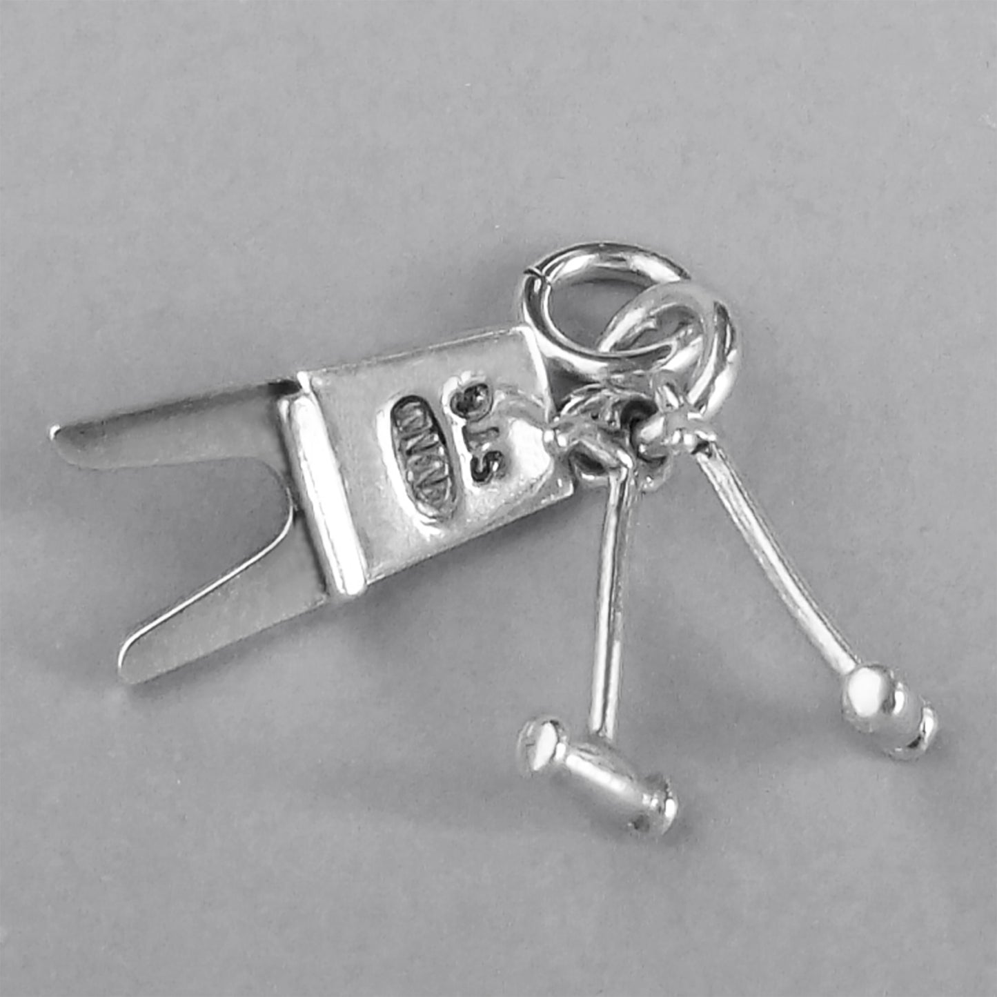Boot Jack and Pulls Charm Sterling Silver on a grey background