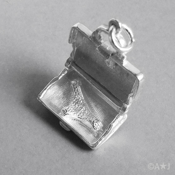 Sterling silver briefcase charm which opens to lingerie on a white background