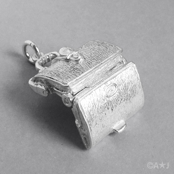 Sterling silver briefcase charm which opens to lingerie on a white background