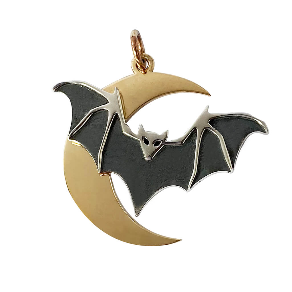 silver and bronze bat and moon charm