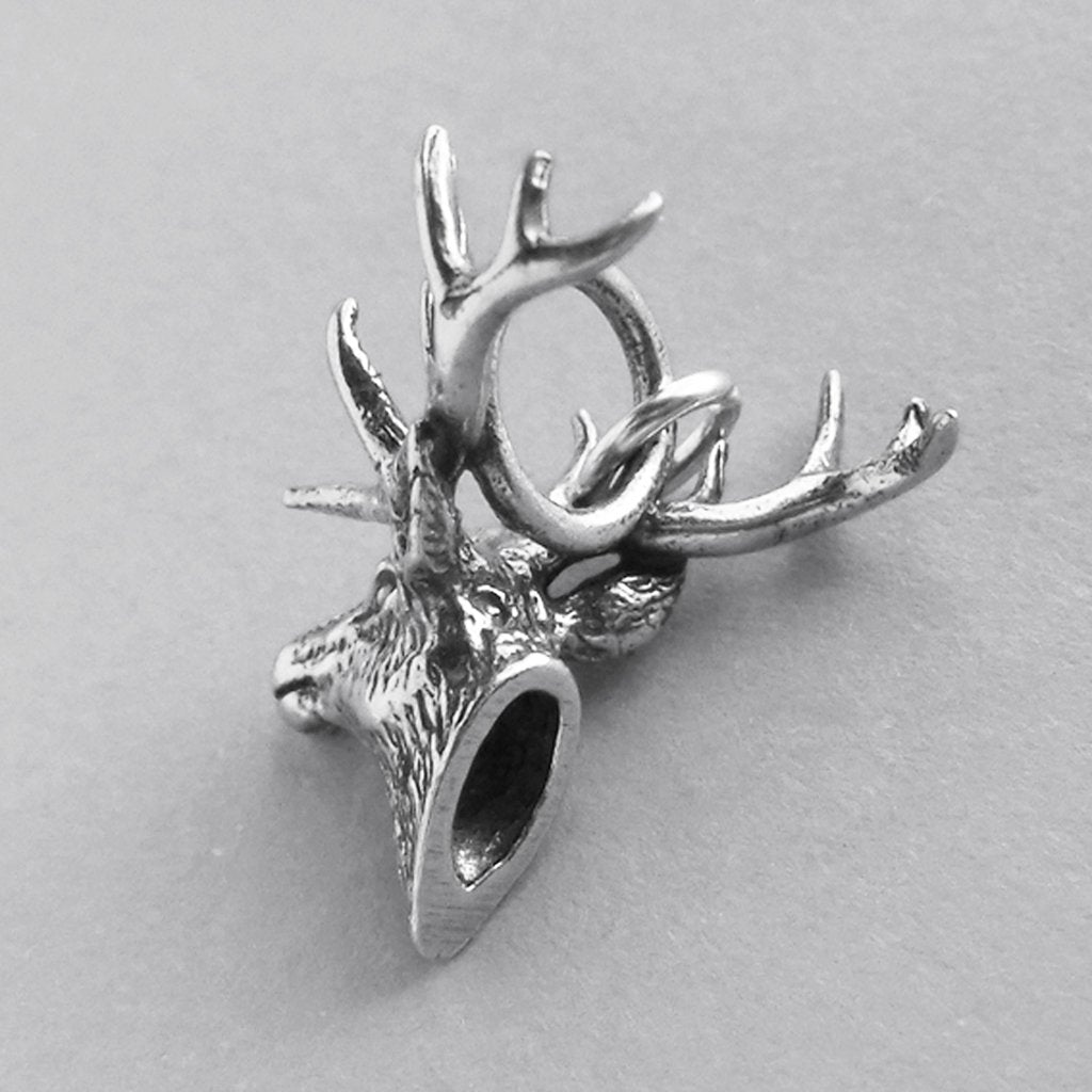 silver elk head charm viewed from back on grey background