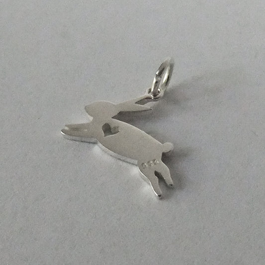 silver rabbit charm silhouette with heart on grey background