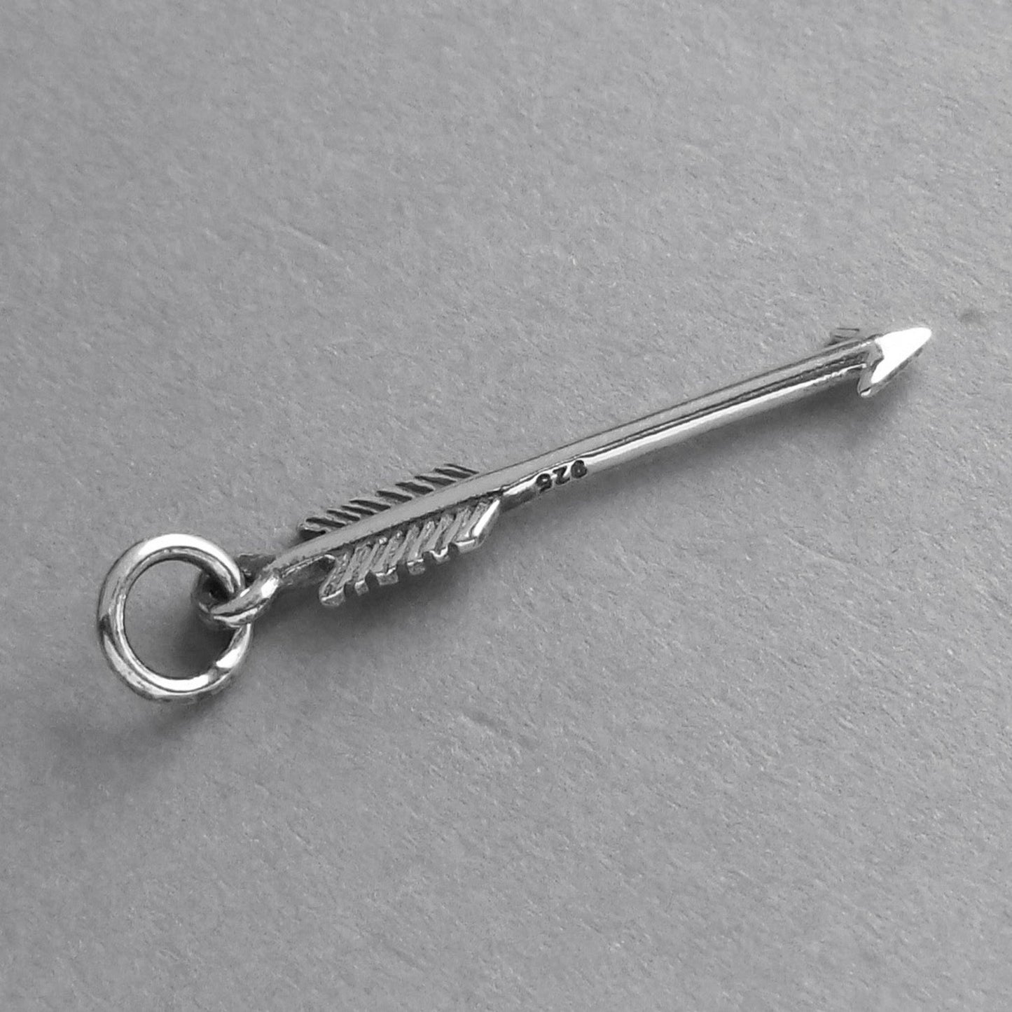 A finely detailed sterling silver archer's arrow charm