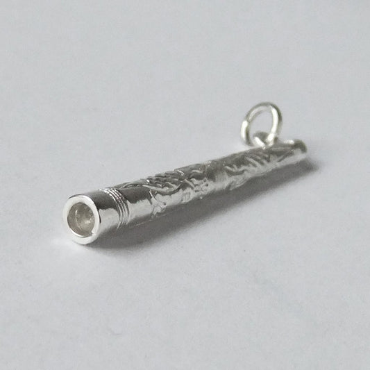 Sterling silver Didgeridoo charm on a grey background
