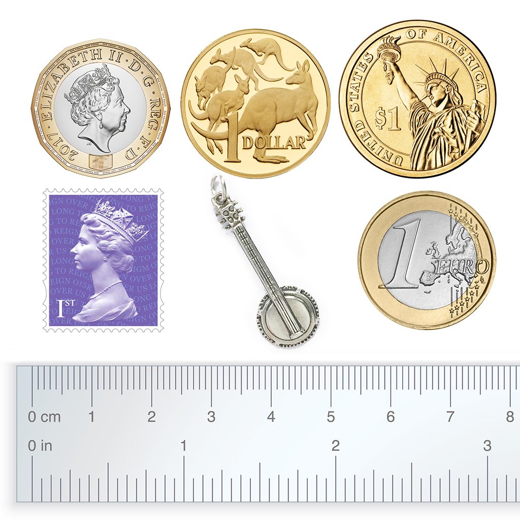 banjo charm with coins stamp and ruler for scale