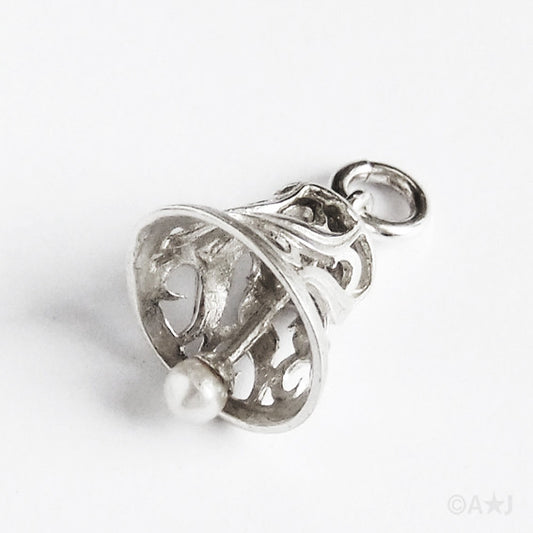Silver bell pendant with pearl clapper on a grey background