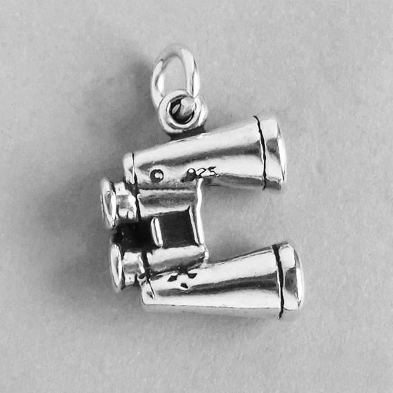 silver binoculars charm on grey background